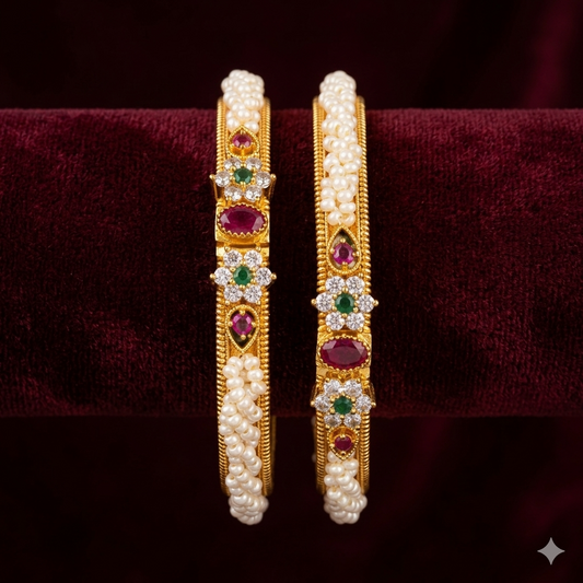 Gold hoop earrings with pearls and gemstones on a dark background
