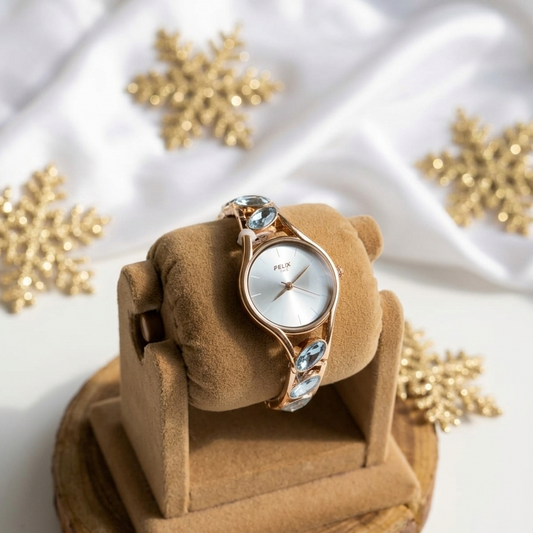 Watch on a brown cushion with gold snowflakes in the background