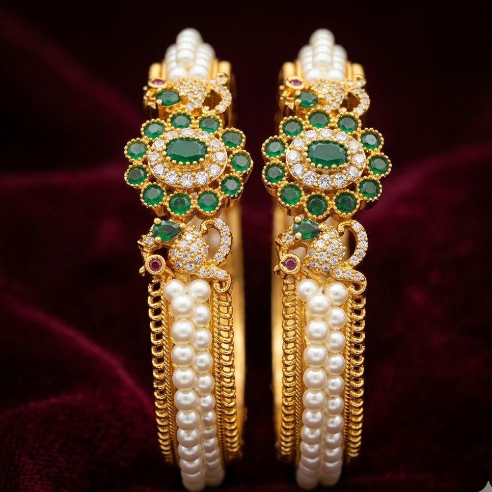 pair of ornate gold earrings with green gemstones and pearl accents on a dark background